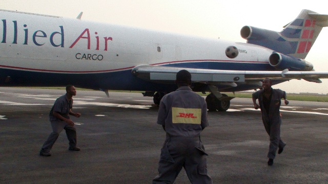 DHL staff play with The Ball on the tarmac