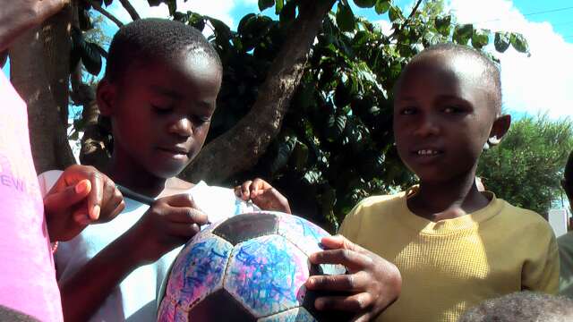 Young orphanage residents sign The Ball