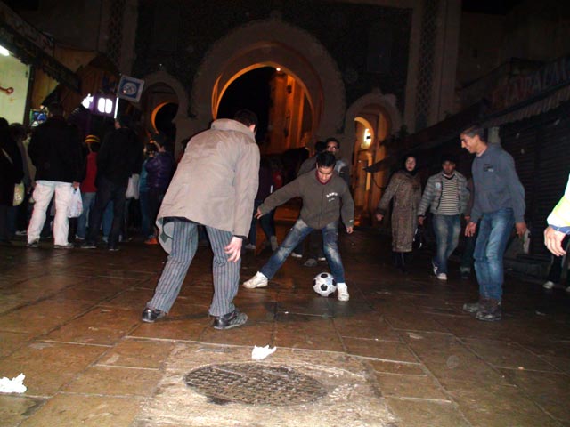 Playing football near one of the medina gates