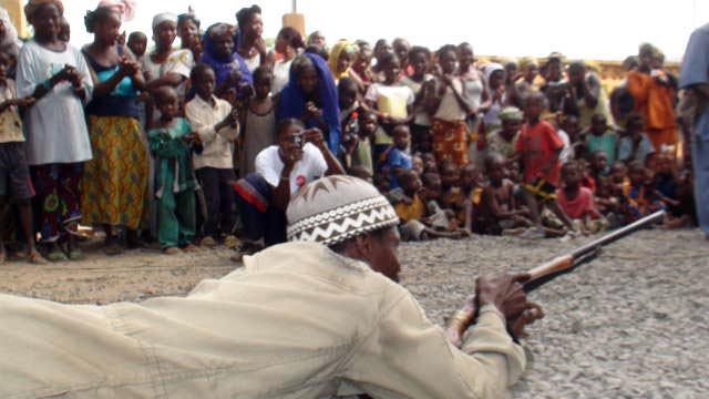 Siby hunter dances with a gun