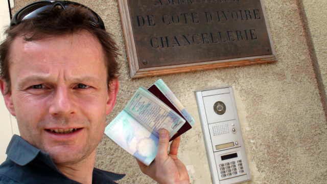 Phil proudly shows off our Ivory Coast visas