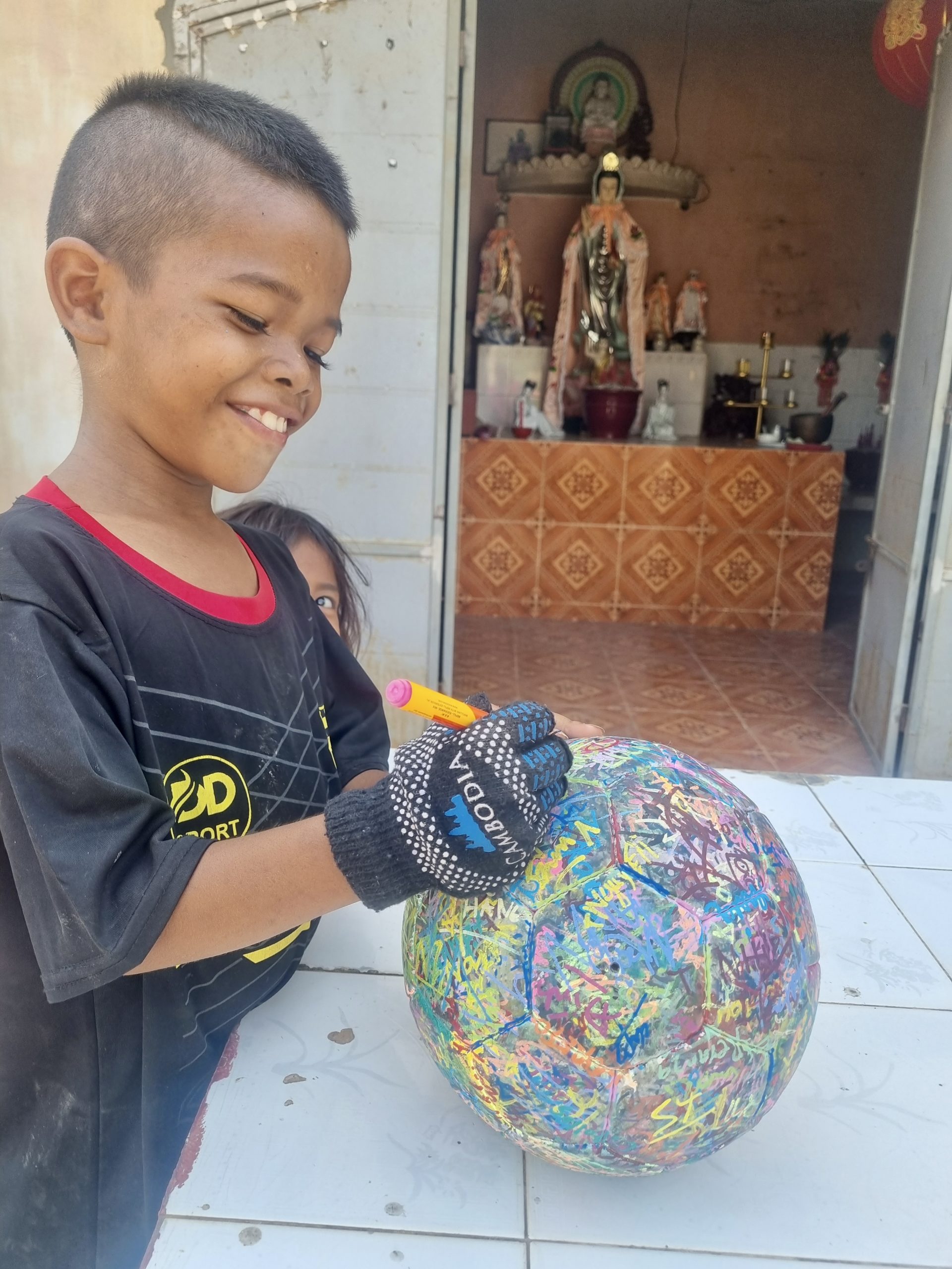 Cambodian child signs The Ball
