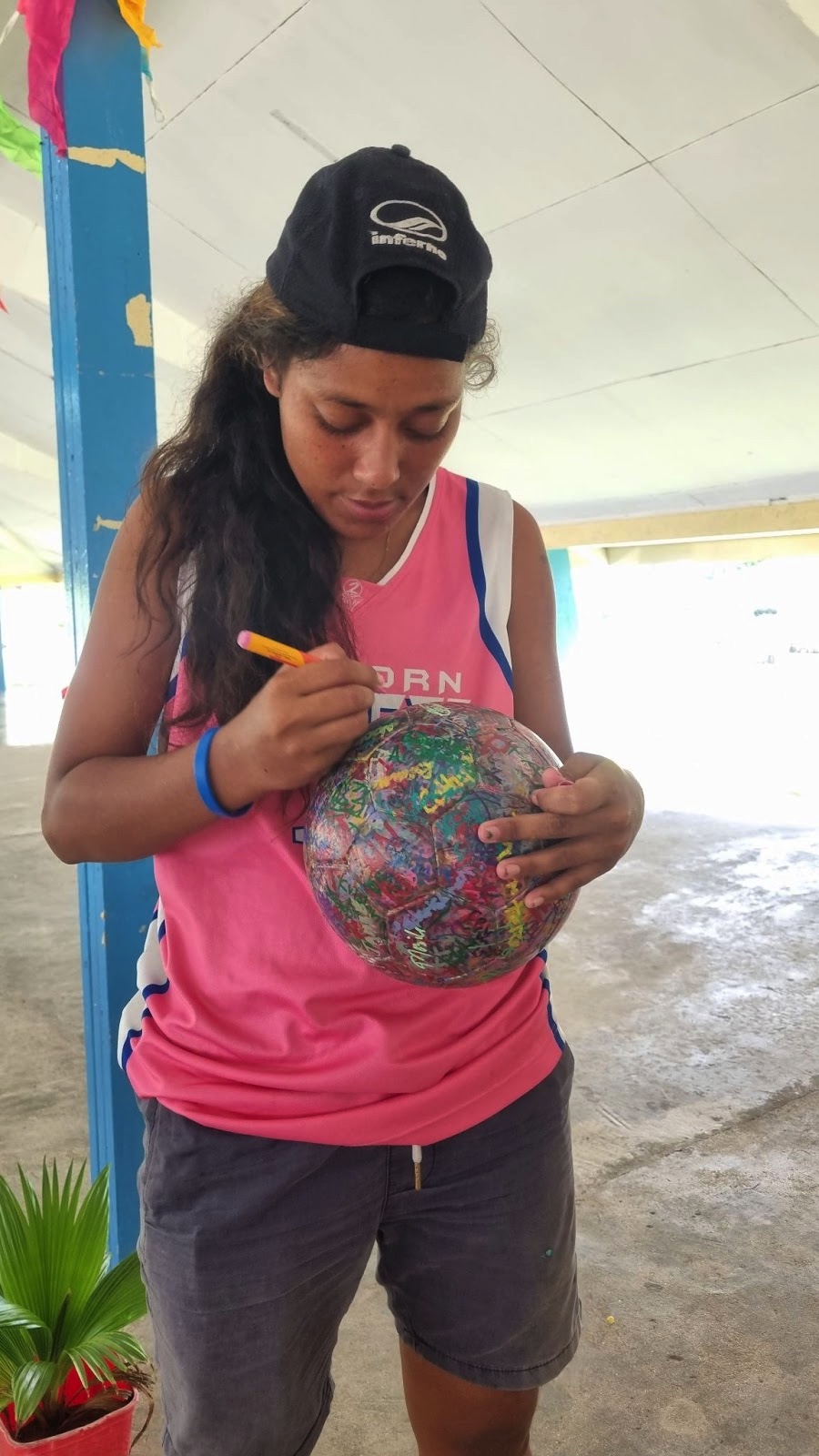 Betio girl signing the ball