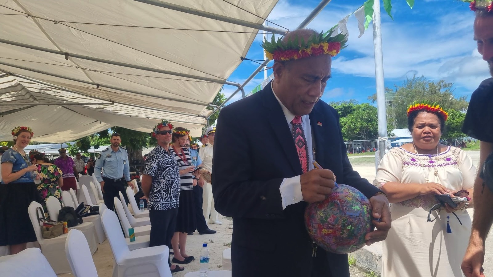 President of Kiribati, H.E. Taneti Maamau signing the ball