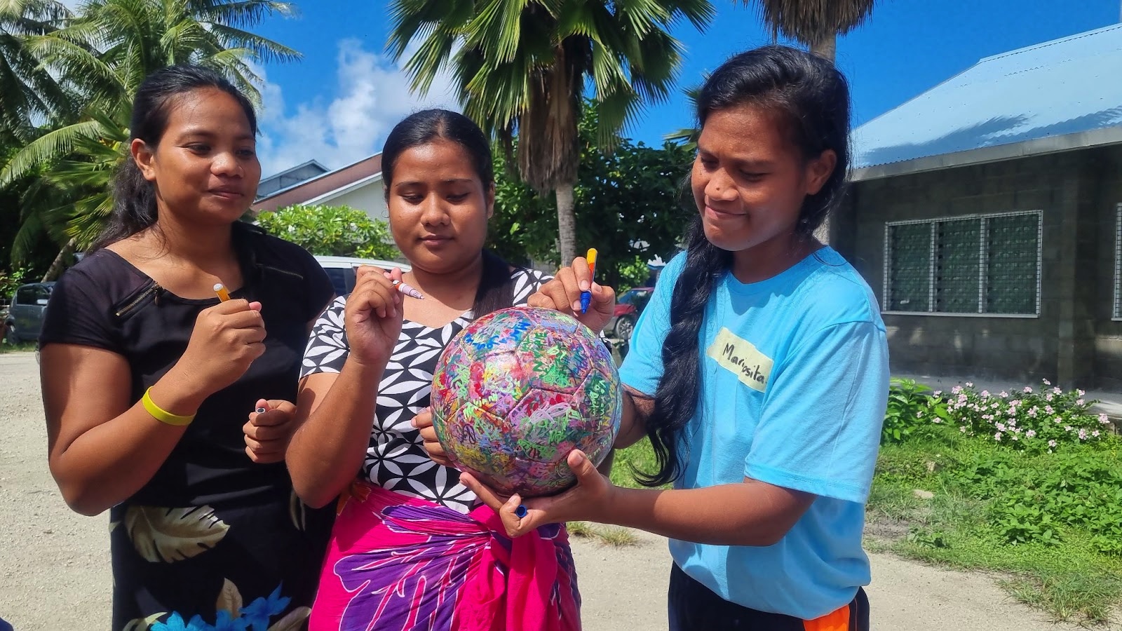 Mariajosita (on the right) and her teammates signing The Ball