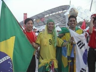 Two Brazilians from the ferry pose with Chinese supporters